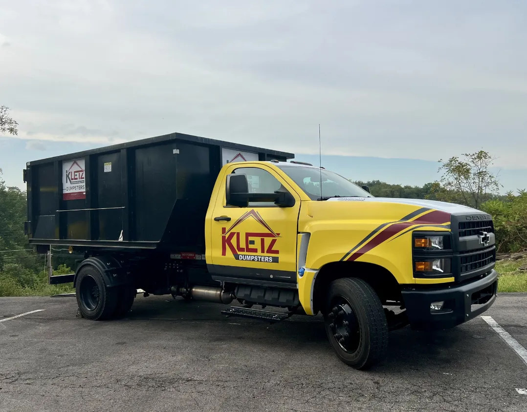 Kletz Contracting branded dumpster delivery truck